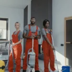 Painter spraying exterior siding of Marietta home using professional sprayer.